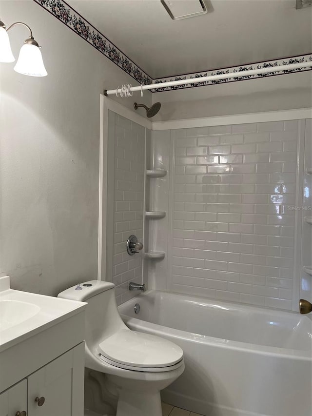 full bathroom with tile patterned floors, vanity, toilet, and tiled shower / bath combo