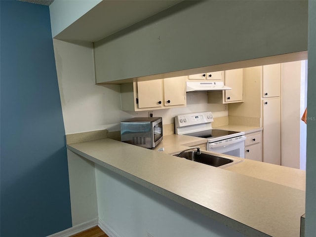 kitchen with white cabinetry, sink, and white electric range oven