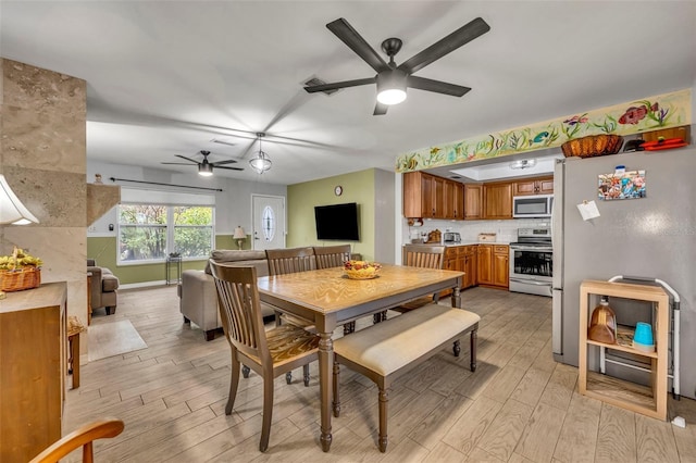 dining room featuring ceiling fan and light hardwood / wood-style floors