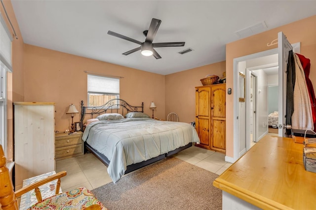 tiled bedroom with ceiling fan