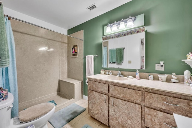 bathroom featuring walk in shower, tile patterned floors, toilet, and vanity