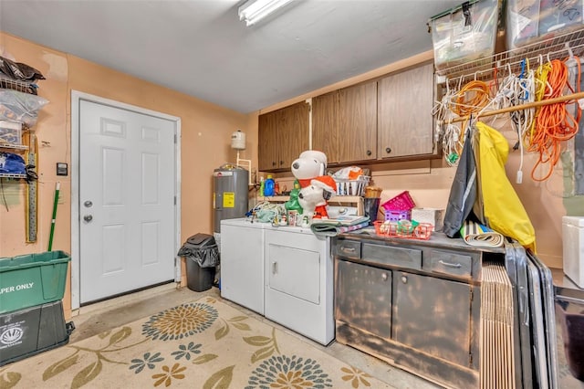 laundry area with separate washer and dryer, electric water heater, and cabinets