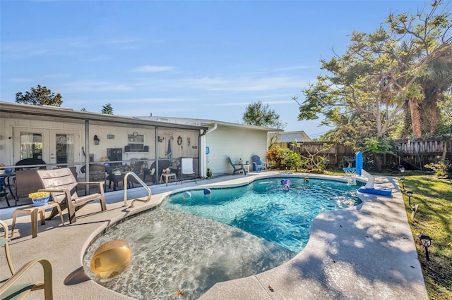 view of pool featuring a patio area and french doors