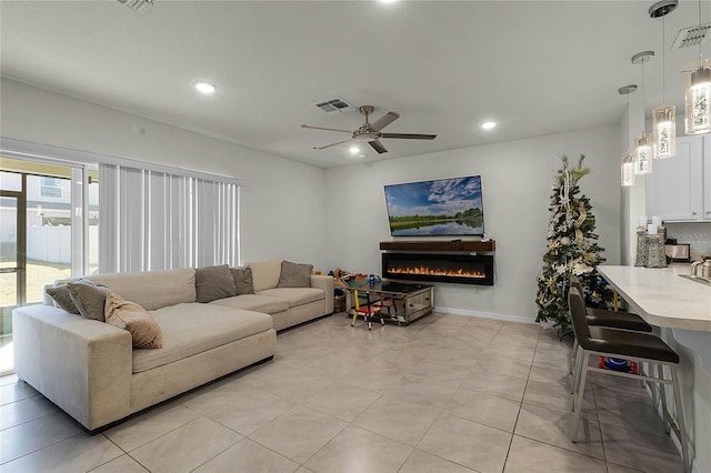 living room featuring ceiling fan and light tile patterned floors