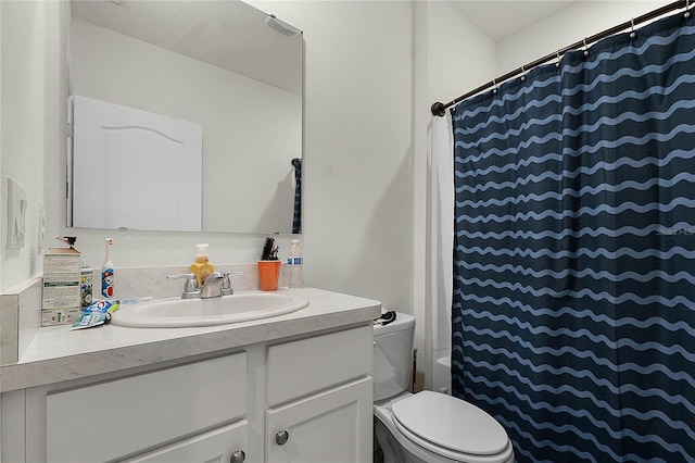 bathroom featuring vanity, toilet, and walk in shower