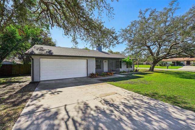 single story home featuring a front lawn and a garage