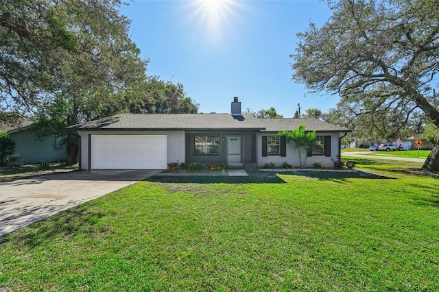 ranch-style home featuring a garage and a front lawn