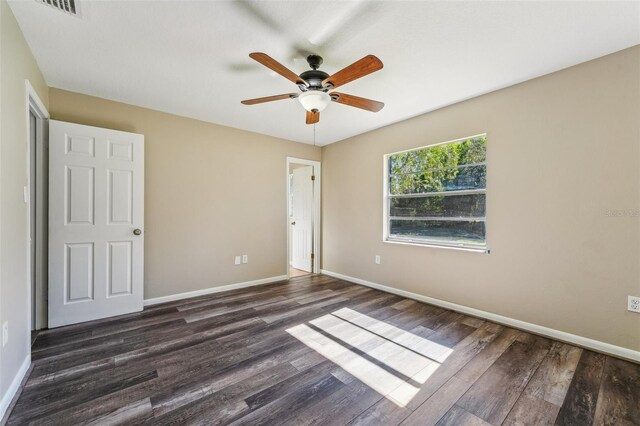 unfurnished bedroom with ceiling fan and dark hardwood / wood-style flooring