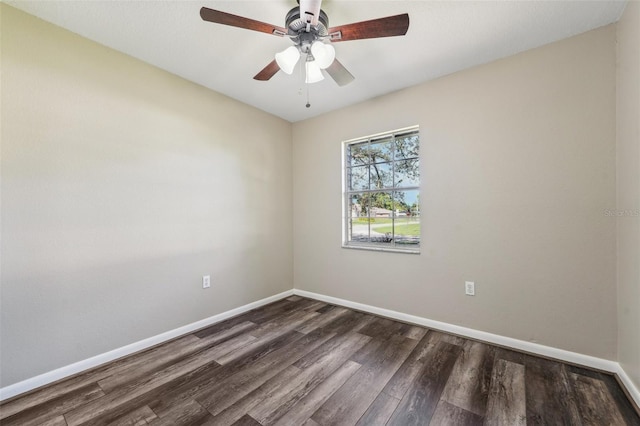 spare room with dark hardwood / wood-style floors and ceiling fan