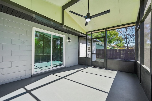 unfurnished sunroom featuring lofted ceiling with beams and ceiling fan