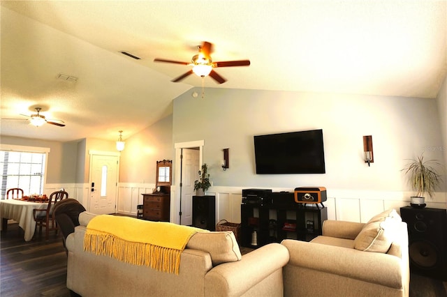 living room featuring ceiling fan, dark wood-type flooring, and vaulted ceiling