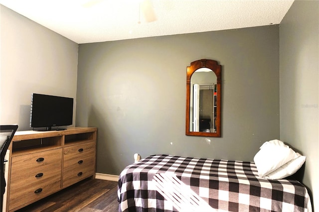 bedroom with ceiling fan and dark hardwood / wood-style flooring