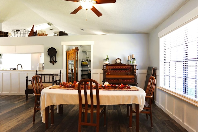 dining room featuring ceiling fan, dark hardwood / wood-style flooring, lofted ceiling, and sink