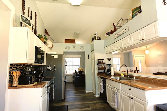 kitchen featuring sink, dark hardwood / wood-style flooring, decorative backsplash, white cabinets, and black appliances