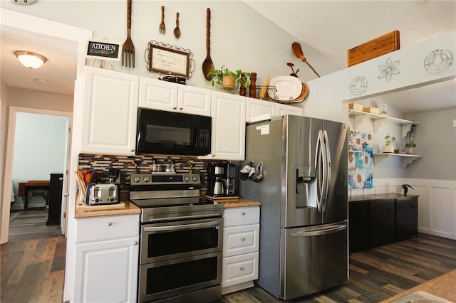 kitchen with white cabinets, appliances with stainless steel finishes, and dark hardwood / wood-style flooring