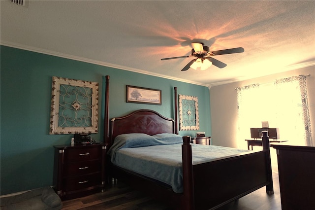 bedroom with ceiling fan, hardwood / wood-style floors, crown molding, and a textured ceiling