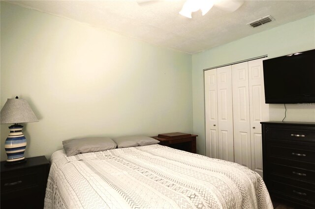 bedroom with ceiling fan and a closet