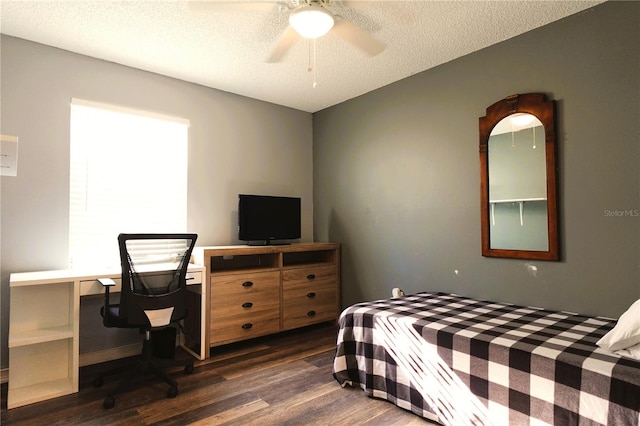 bedroom featuring ceiling fan, dark hardwood / wood-style flooring, and a textured ceiling