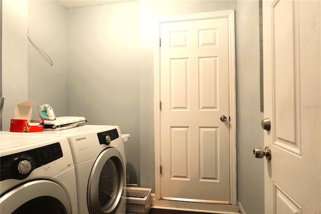 clothes washing area with a textured ceiling and washing machine and clothes dryer