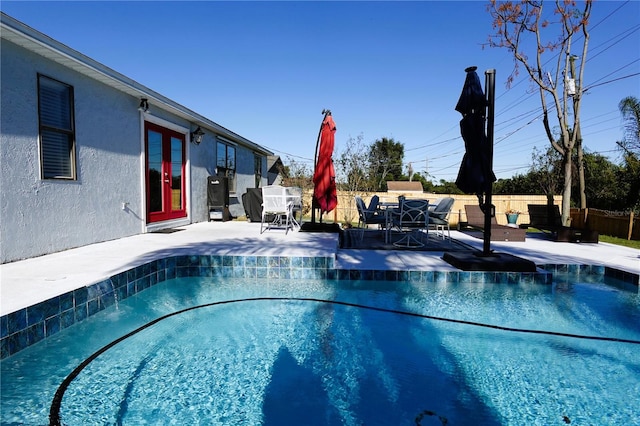 view of pool featuring french doors and a patio area