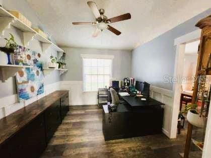 office featuring ceiling fan and dark wood-type flooring