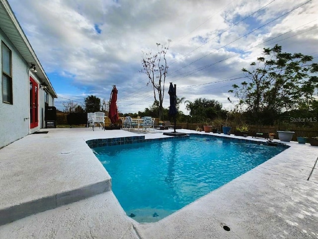 view of swimming pool featuring a patio area