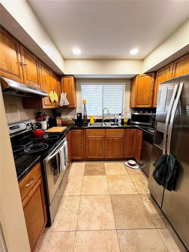 kitchen with backsplash, dark stone counters, stainless steel appliances, sink, and light tile patterned floors