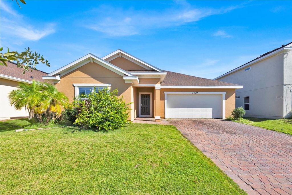 view of front of house featuring a garage and a front lawn