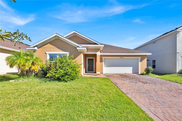 view of front of house featuring a garage and a front lawn