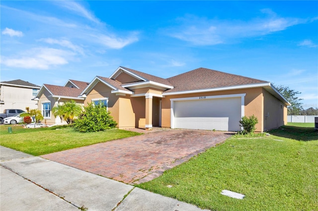 view of front of house featuring a garage and a front lawn