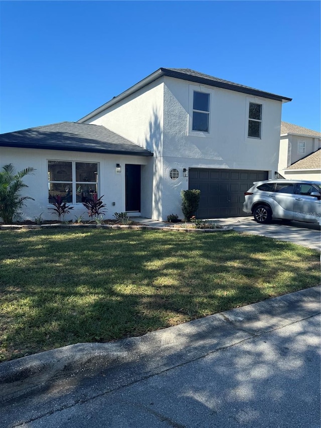 view of front of property featuring a garage and a front lawn