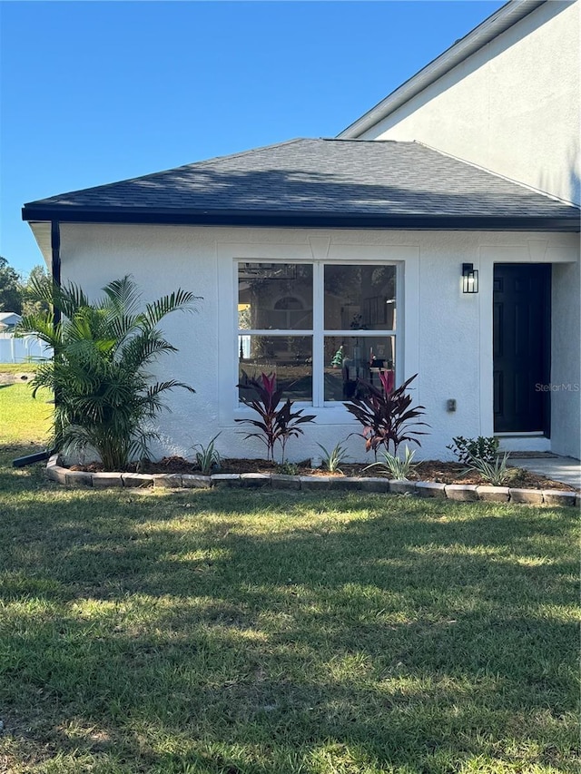 view of property exterior with a yard