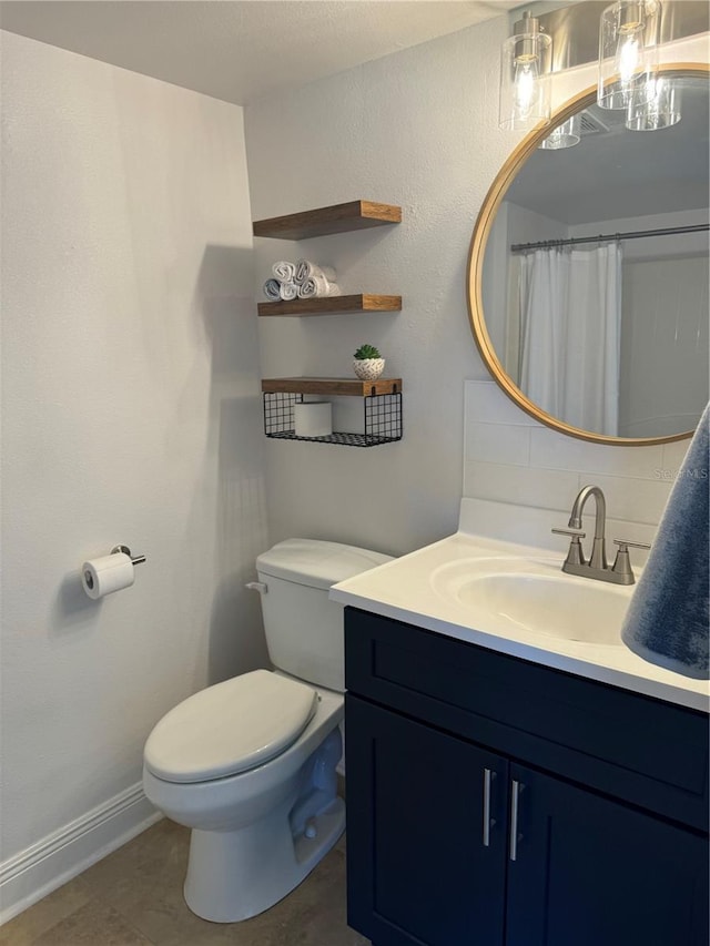 bathroom featuring tile patterned floors, vanity, and toilet