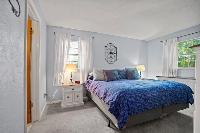 carpeted bedroom featuring a textured ceiling