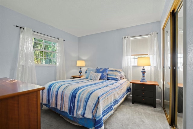 bedroom featuring light carpet