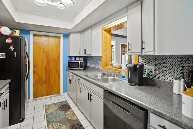 kitchen with backsplash, sink, white cabinets, and black appliances