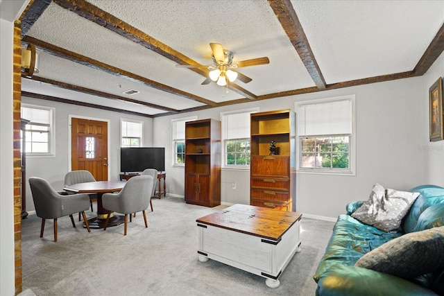 living room with ceiling fan, carpet, a healthy amount of sunlight, and a textured ceiling