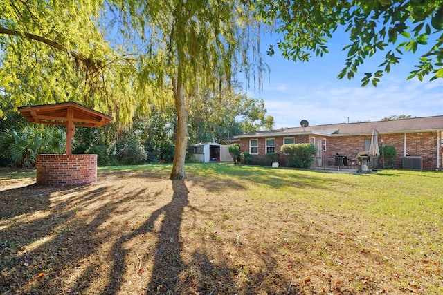 view of yard with a storage unit and central AC