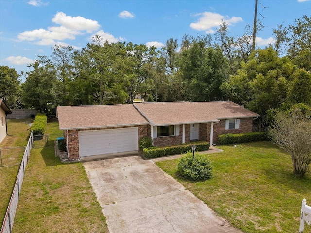 ranch-style house featuring a front yard, an attached garage, fence, brick siding, and driveway