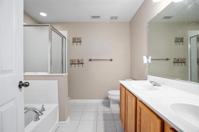 full bathroom featuring tile patterned floors, a textured ceiling, toilet, vanity, and independent shower and bath