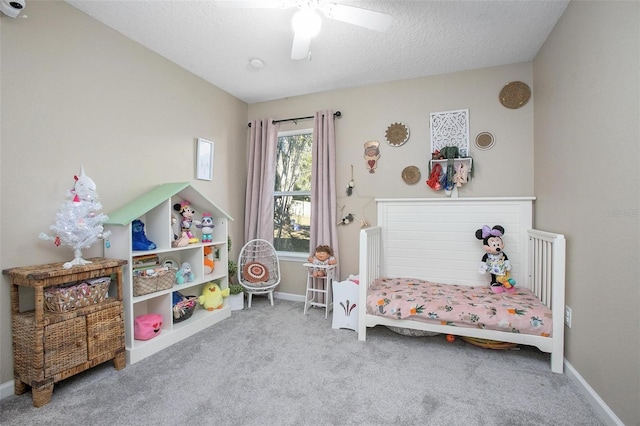 carpeted bedroom with ceiling fan and a textured ceiling