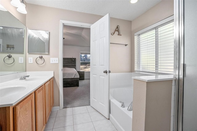 bathroom with tile patterned floors, lofted ceiling, a bath, and a textured ceiling