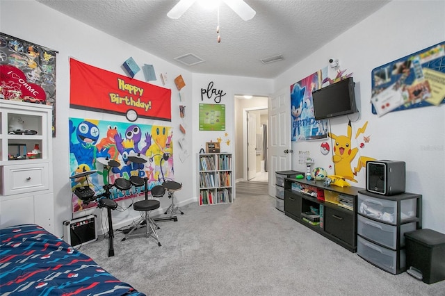 bedroom with carpet flooring, a textured ceiling, and ceiling fan