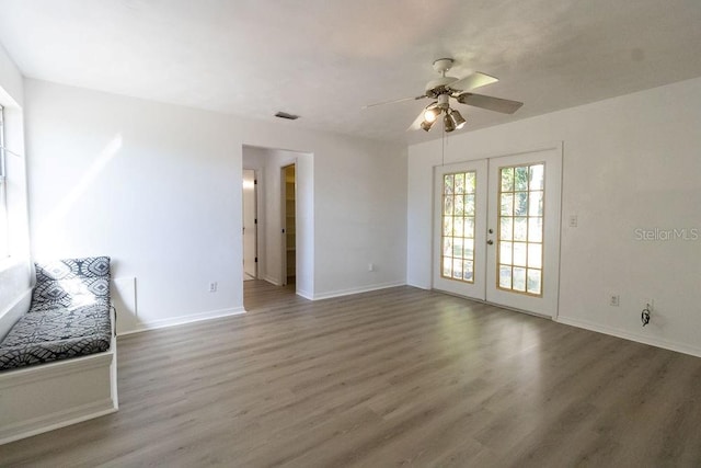 spare room featuring french doors, dark hardwood / wood-style flooring, and ceiling fan