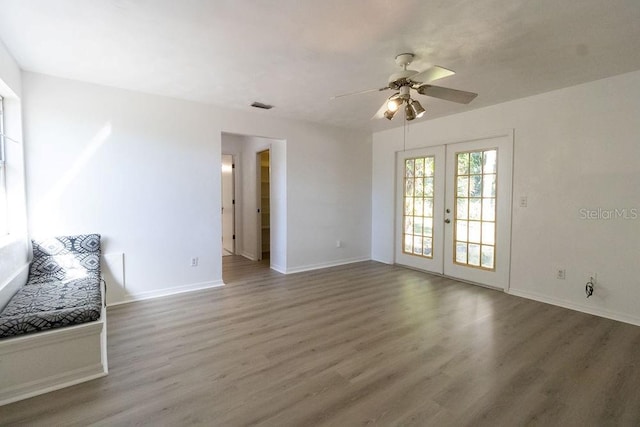 1068 N St, Daytona Beach, FL 32114 - unfurnished living room with wood finished floors, french doors, ceiling fan, and baseboards