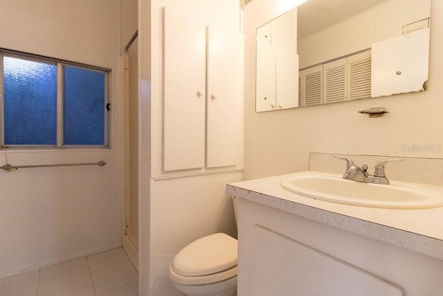 bathroom featuring tile patterned flooring, vanity, and toilet