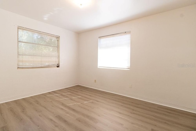 spare room with wood-type flooring