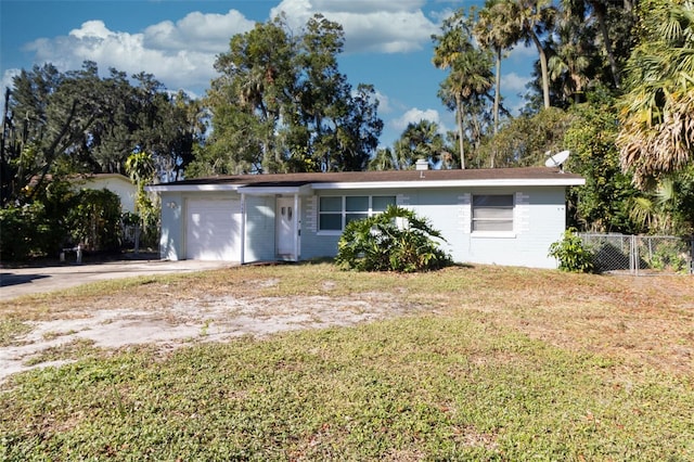 ranch-style house with a garage and a front yard