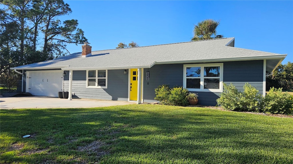 ranch-style home with a front yard and a garage