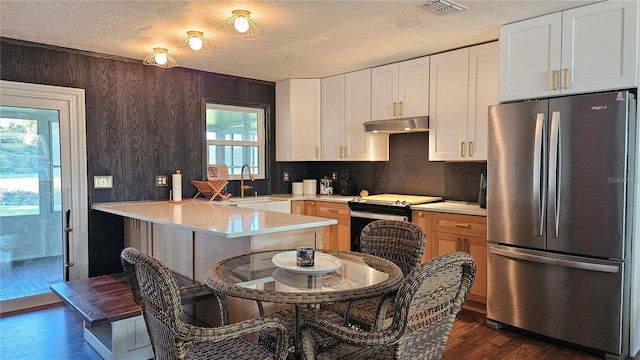 kitchen with sink, stainless steel fridge, electric range oven, dark hardwood / wood-style flooring, and white cabinetry